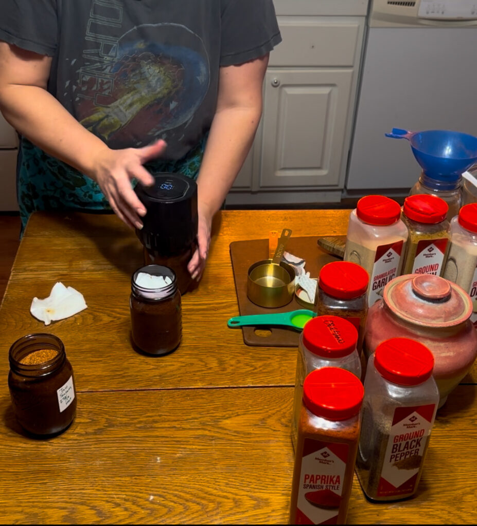 lady putting electric canner on canning jars to vacuum seal dry goods. 